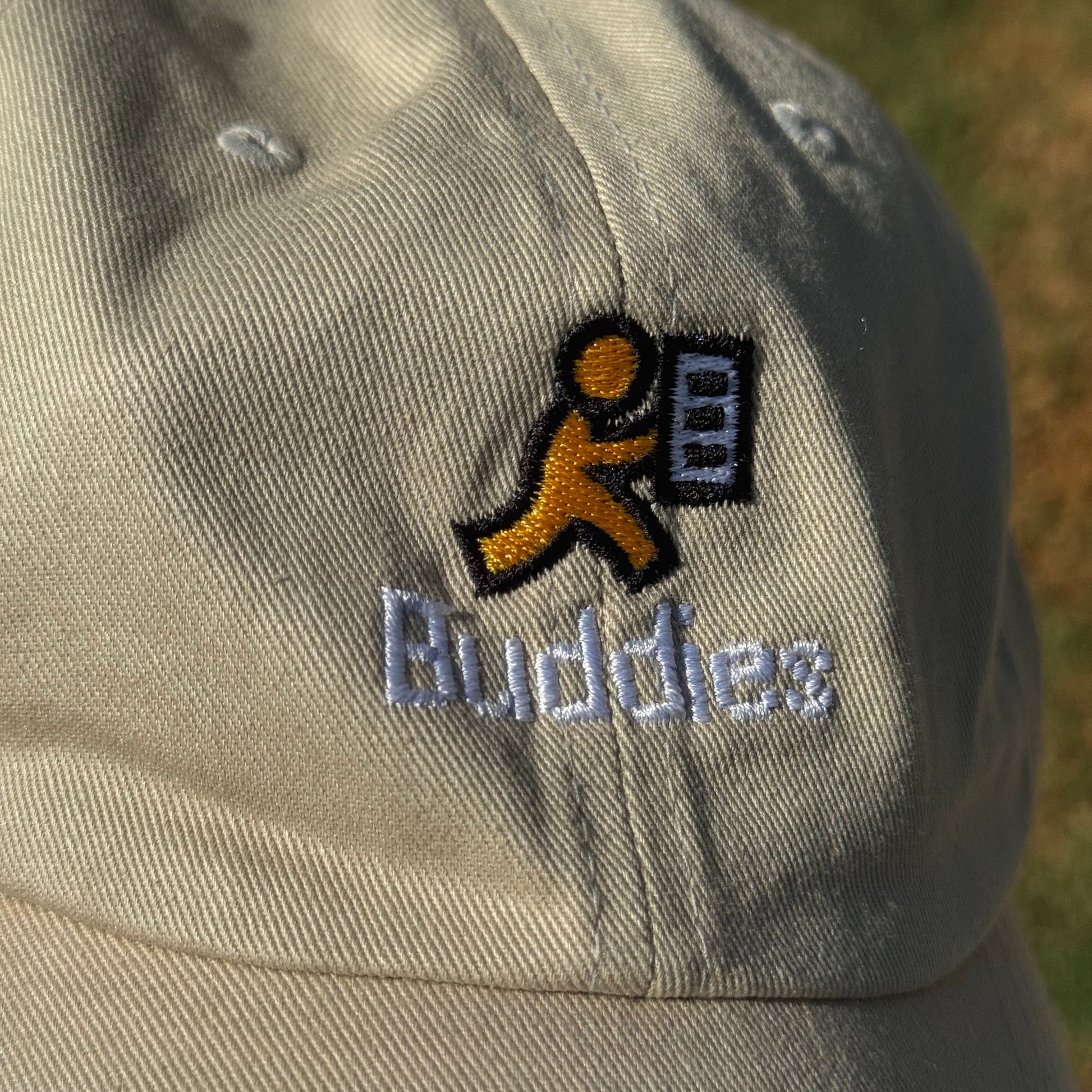 Close-up of a cap with a AOL's AIM Buddy List icon and text on a blurred background