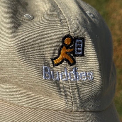 Close-up of a cap with a AOL's AIM Buddy List icon and text on a blurred background